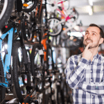 man looking at bicycle accessories