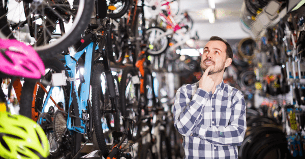 man looking at bicycle accessories